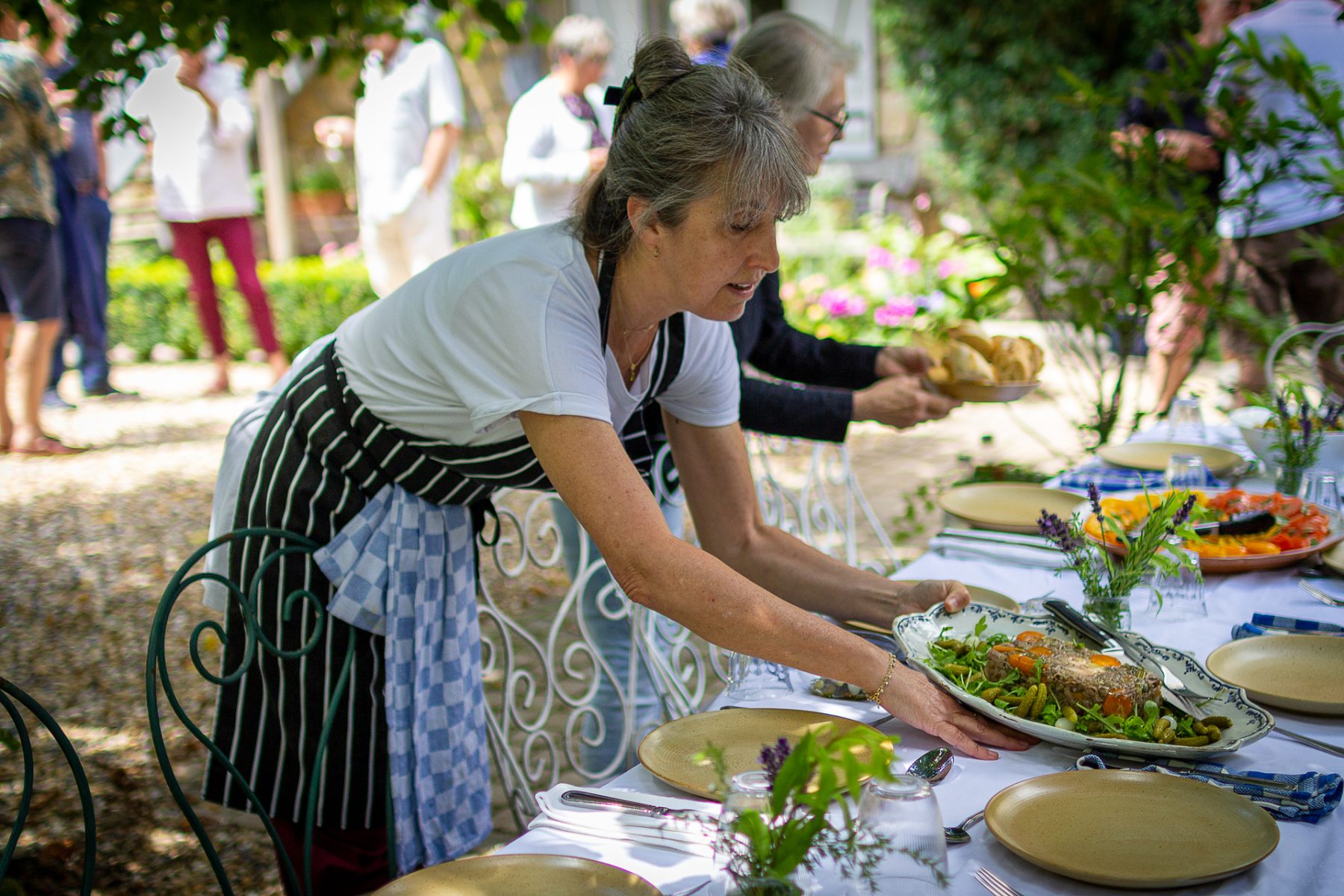 Cookbook author and teacher, Laura Washburn, preparing the table for lunch.